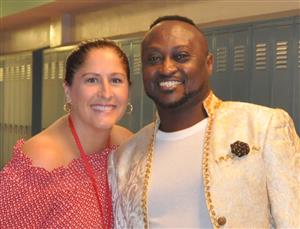 Abisi teacher posing with student at graduation