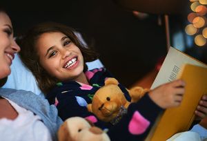 child reading to mother